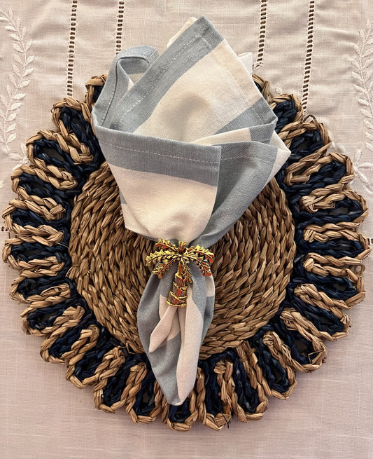Blue and white strip napkin and navy woven placemat