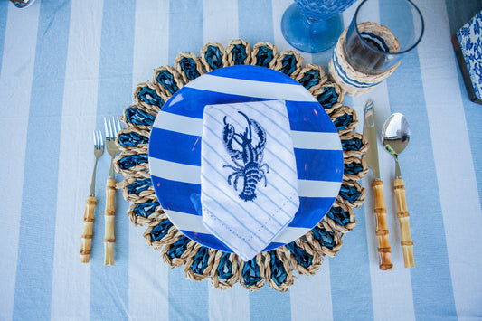 Navy dual woven placemats paired with lobster embroidered napkin
