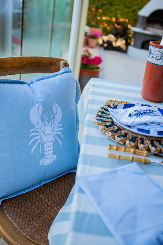 Blue lobster cushion with coastal blue table setting