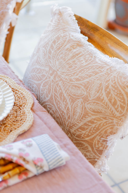 Close-up of textured pillows on a couch with a decorative item.