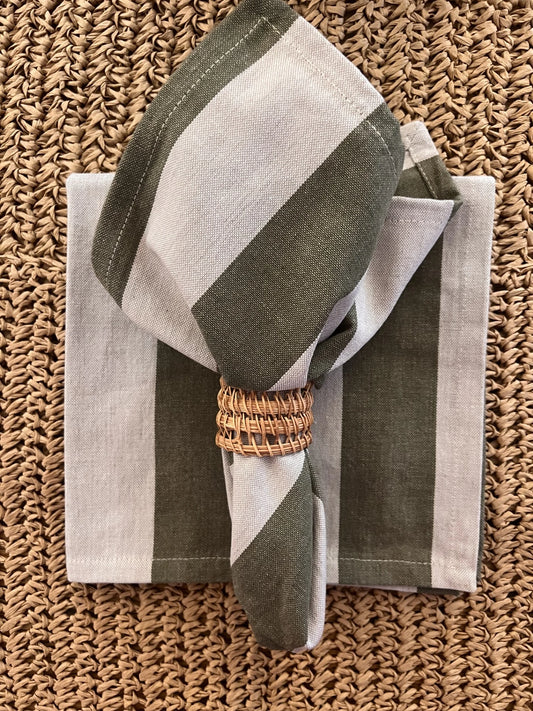 Striped napkin with a woven ring on a textured surface
