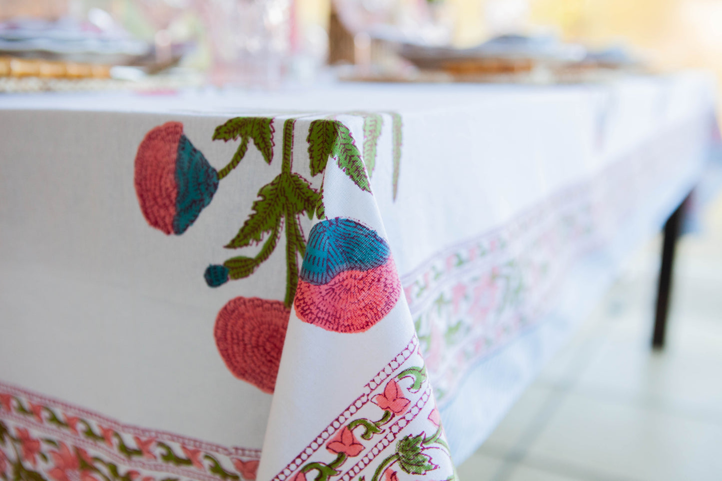 Decorative tablecloth with floral and fruit pattern on a blurred background